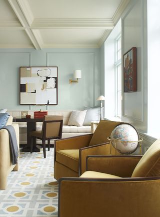 Living room in mint green with leather sofas