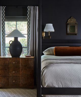 bedroom with black walls and four poster bed