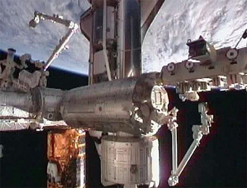 NASA&#039;s space shuttle Discovery is shown docked to the International Space Station shortly after arriving on Feb. 26, 2011. The gold spacecraft at the bottom of this view is Japan&#039;s HTV-2 spacecraft. 