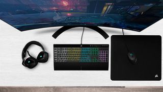 Corsair K55 RGB Pro on a desk with other gaming peripherals