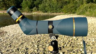 Nocs Provisions Long View 85mm spotting scope on a pebble beach next to a river