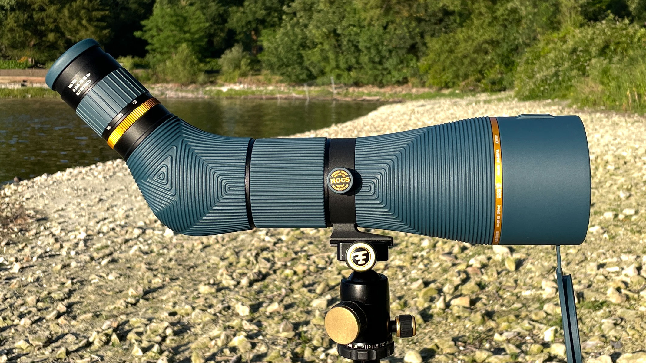 Nocs Provisions Long View 85mm spotting scope on a pebble beach next to a river