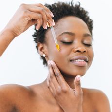 woman applying facial serum