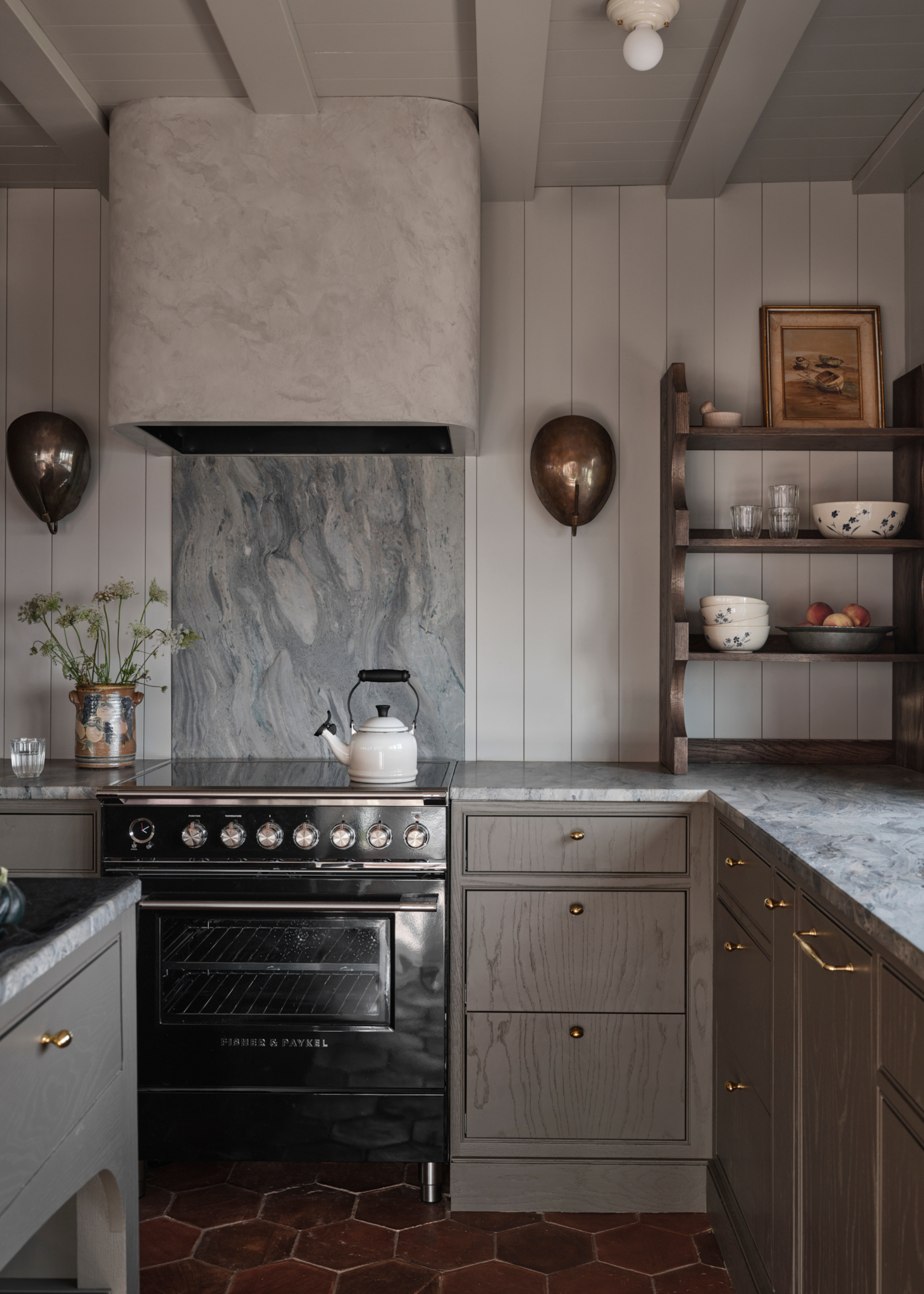 A light gray color-drenched kitchenwith hexagonal teracotta tiles and lots of pretty details