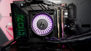 An Arctic Liquid Freezer III Pro liquid cooler set-up on a test bench with the RGB enabled.