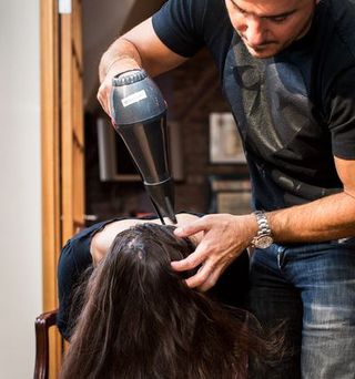 Hairstyle, Wrist, Elbow, Beauty salon, Watch, Hairdresser, Personal grooming, Glove, Long hair, Hair coloring,