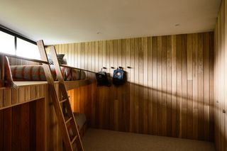 Bedroom with bunk beds and oak slated walls