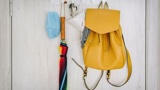 Keys and a bag hanging up in a hallway, used to demonstrate the importance of items having a 'home' when you are trying to declutter