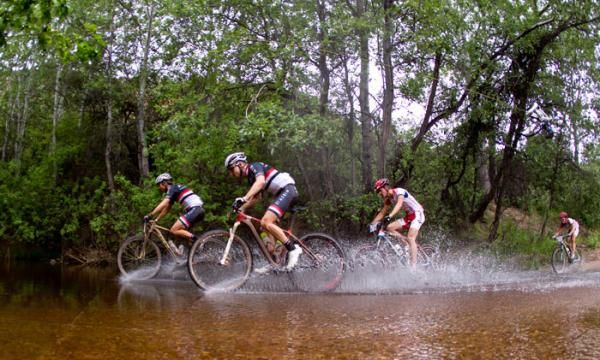 The leading men cross a river during Stage 1