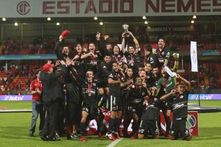 Tijuana players celebrate after beating Toluca to win the Apertura 2012 Liga MX title.