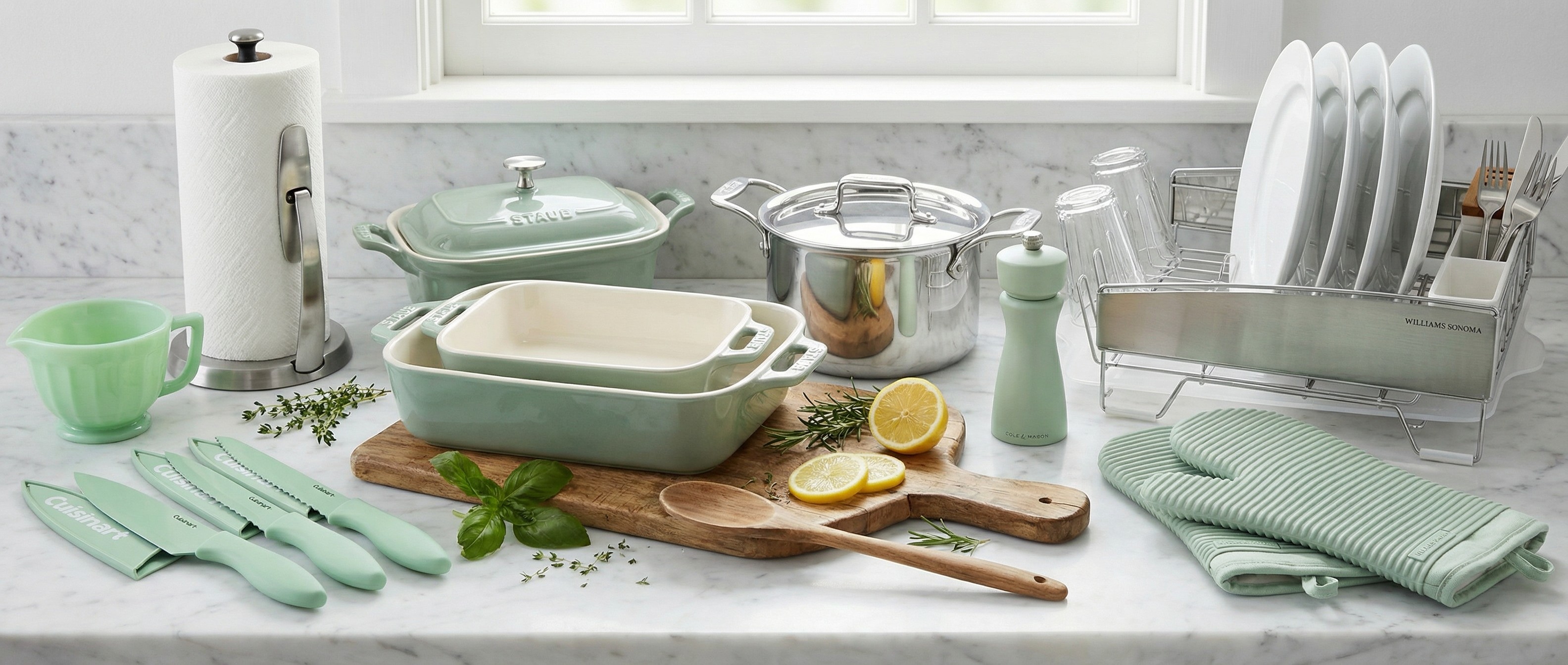 Collection of stainless steel and mint green kitchen accessories on kitchen counter