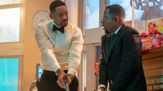 Will Smith looking angrily at Martin Lawrence as they both aim guns towards the floor in Bad Boys: Ride or Die.