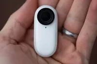 Insta360 Go 2 Action Camera in the image is held in the palm of a hand 