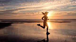 woman running on beach in morning