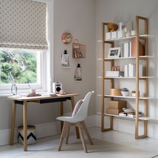 Neutral home offie with freestanding bookshelves and desk