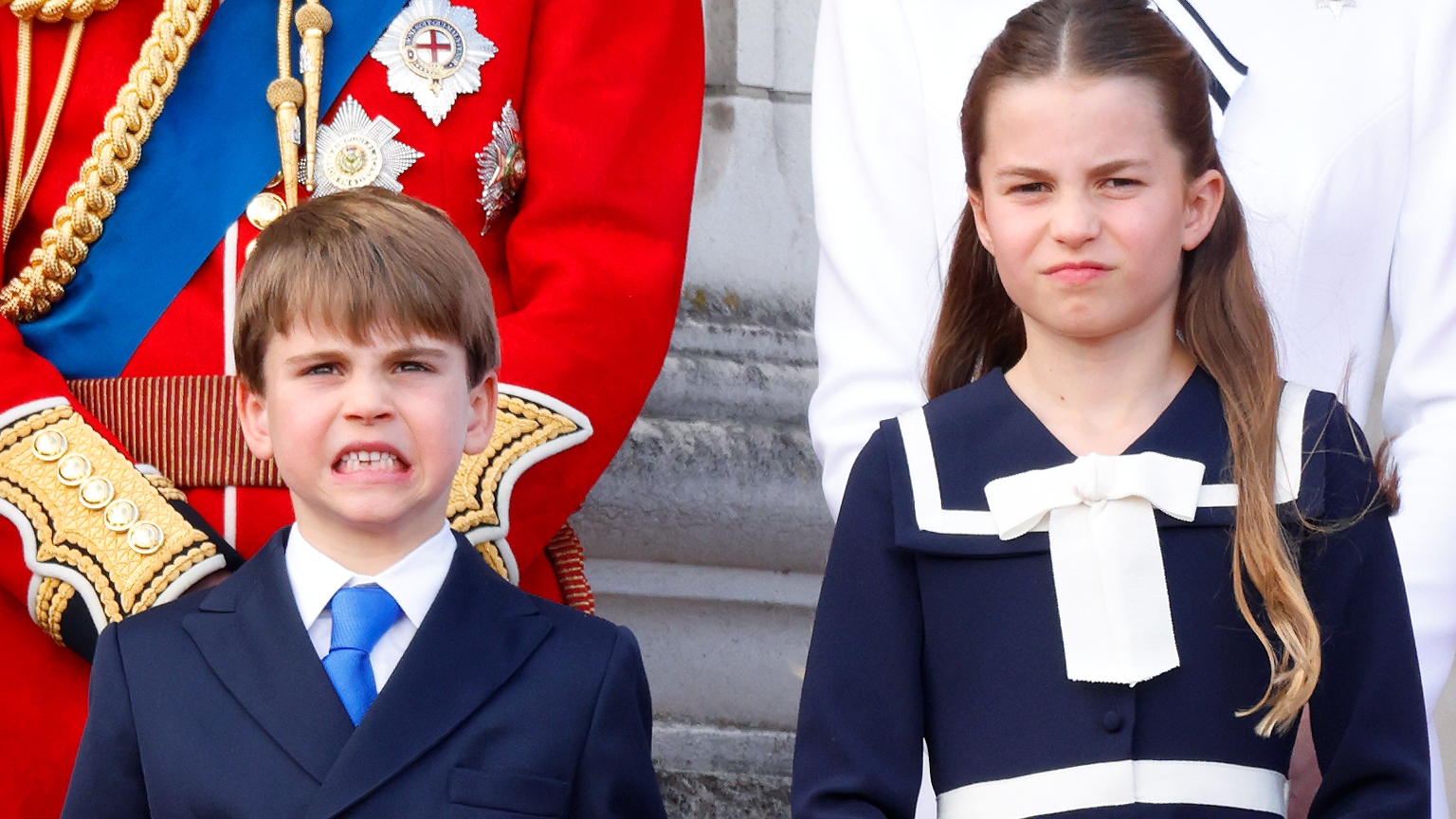 Prince Louis of Wales and Princess Charlotte of Wales watch an RAF flypast from the balcony of Buckingham Palace after attending Trooping the Colour on June 15, 2024 in London
