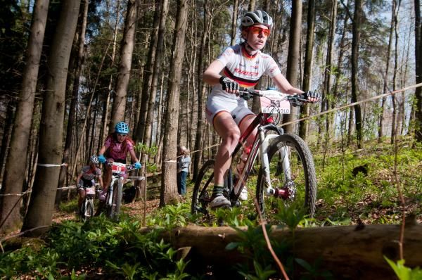 The junior women race through the forest