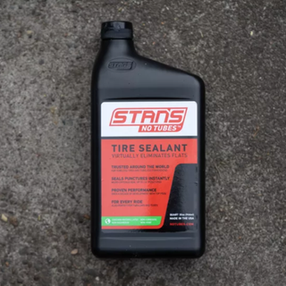 A bottle of Stan’s No Tubes Original on a concrete background