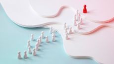 Leadership abstract image with pegs in hierarchical structure and red peg for leader.