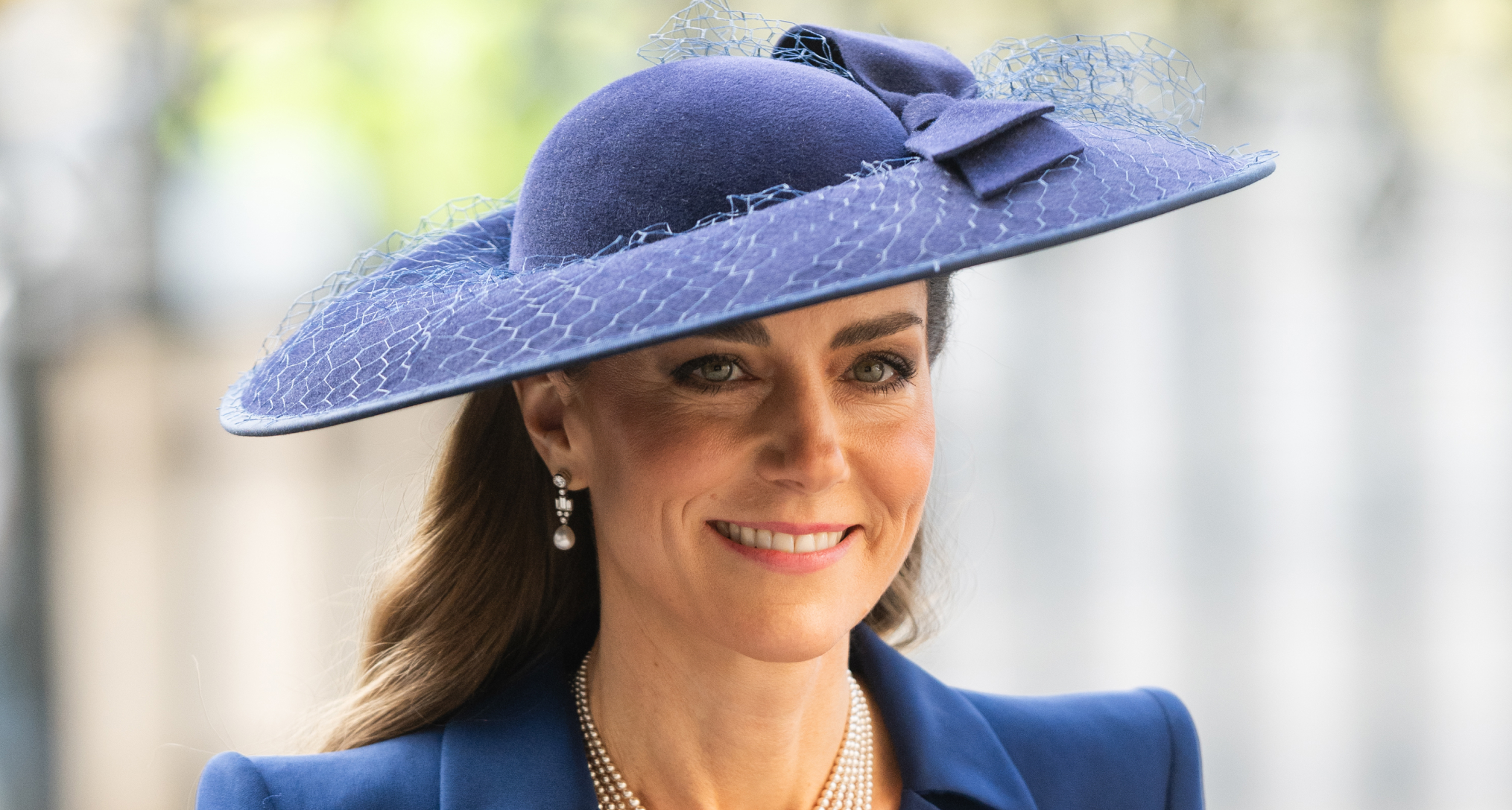Princess Kate wearing a blue hat and coat