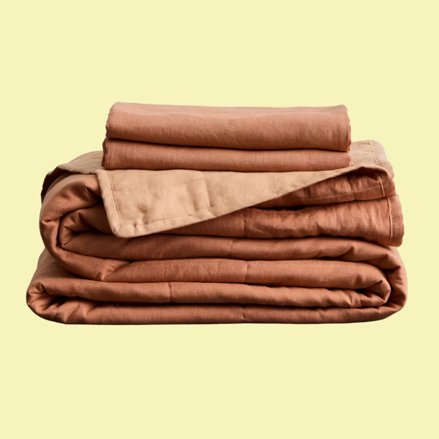 A terracotta and hazelnut colored quilt set