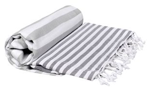 Image of a white and gray stripped bed blanket