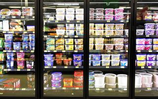 Ice cream tubs in the frozen food aisle.
