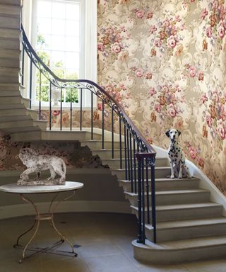 Grand stairwell with floral wallpaper, stone flooring and stairs, Dalmatian on stairs