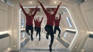 Dancing crewmembers of the starship Enterprise in a corridor