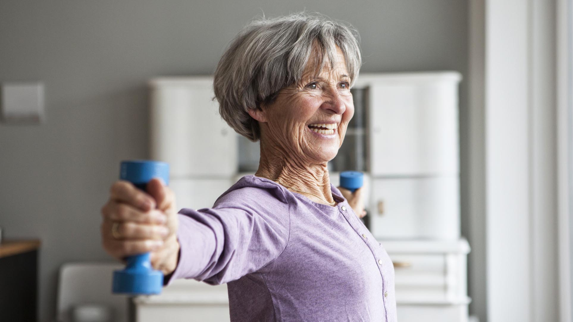 a senior woman doing exercise with weights