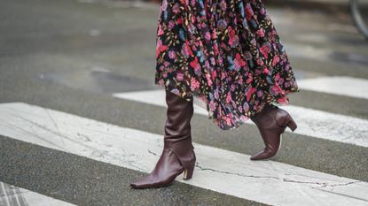 Woman wearing boots and crossing the street
