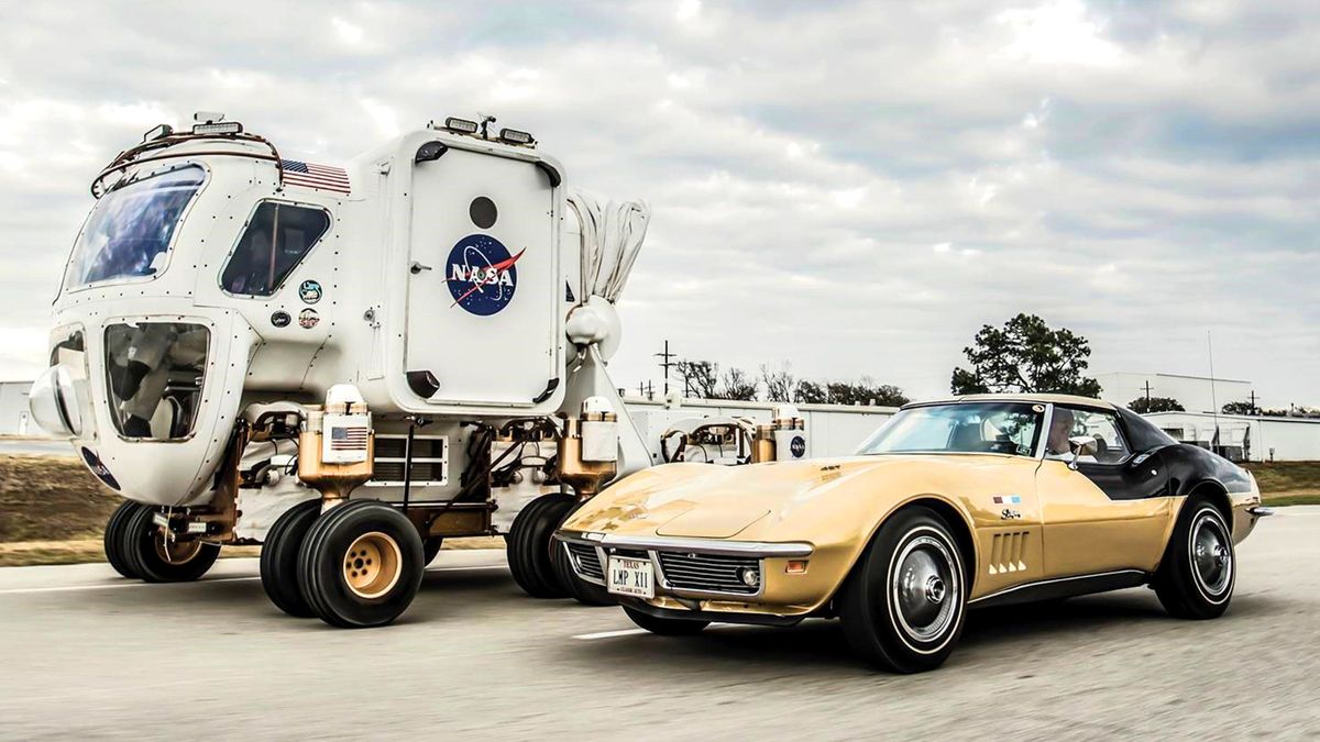 An Astrovette Corvette poses next to a NASA moon rover prototype.