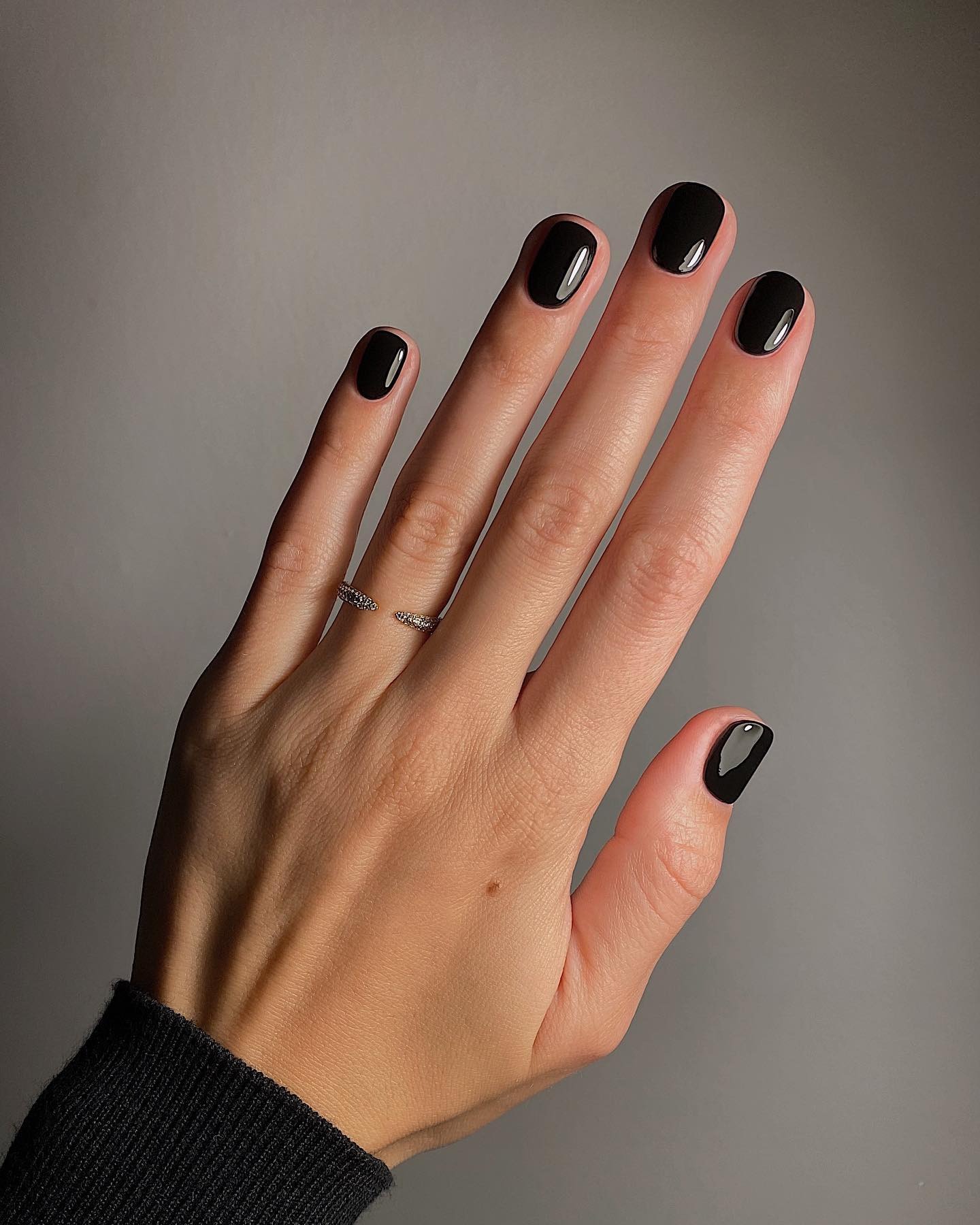 A black manicure on short nails