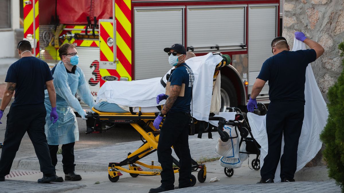 EMS workers pick up a suspected COVID-19 patient in the Rio Grande Historic District of El Paso, Texas, on Nov. 15, 2020. 