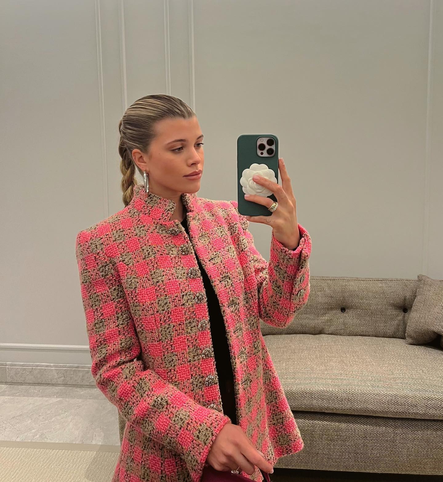 Sofia Grainge taking a mirror selfie with a plaited ponytail