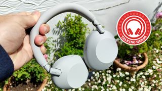 Sony WH-1000XM6 in white with the What Hi-Fi? Talking Heads column roundel