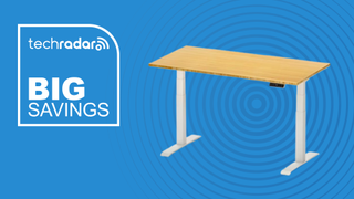 FlexiSpot E7 standing desk on a blue background next to a TechRadar badge reading 'Big Savings'