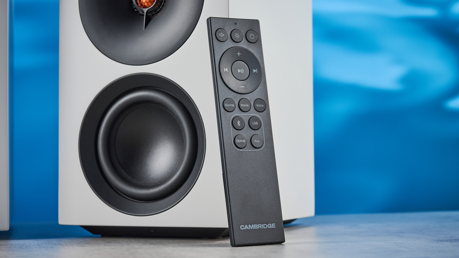 the cambridge audio l/r s bookshelf speakers in white with a 21mm aluminum tweeter and a 3-inch woofer photographed against the blue tom's guide background