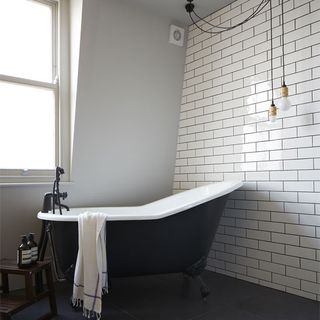 bathroom with white wall and grey bathtub