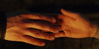 Kylo Ren and Rey touching hands through the Force