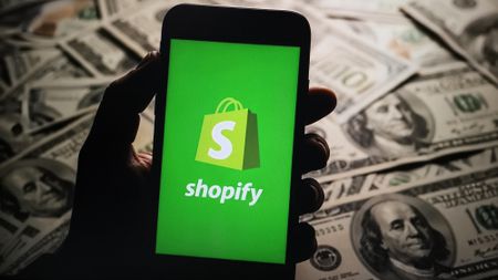 A shopify logo on a phone