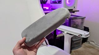 The Secretlab TITAN Evo NanoGen Edition's PlusCell armrest top seen up close and detached from the armrest using the CloudSwap technology.