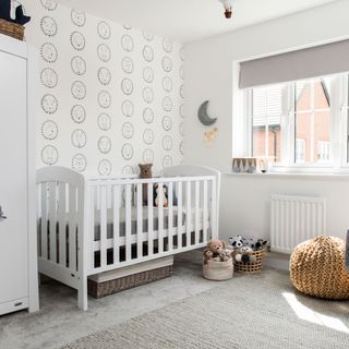 white and grey nursery with subtle patterned wallpaper