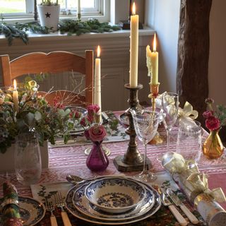 dining room table with pink cloth candles and flower arrangements