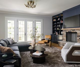 Living room with dark feature wall and stone fireplace