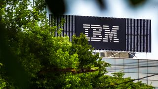 An IBM sign visible through trees
