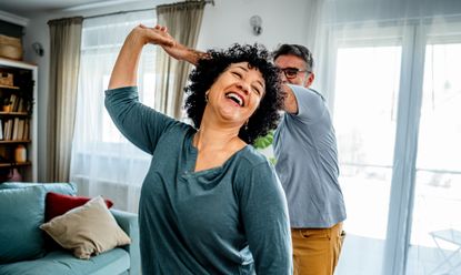 Older couple dancing in the living room