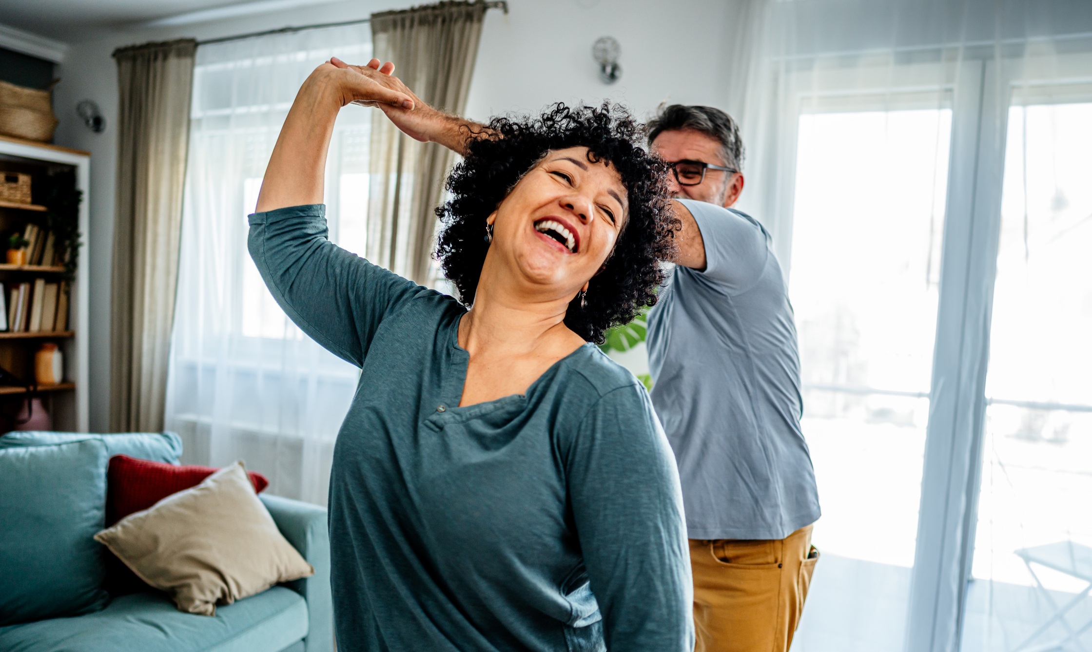 Older couple dancing in the living room