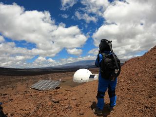 A Valoria 3 crewmember takes a "Marswalk" above the HI-SEAS habitat.