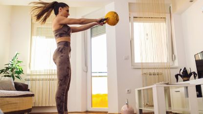 A woman doing a kettlebell workout